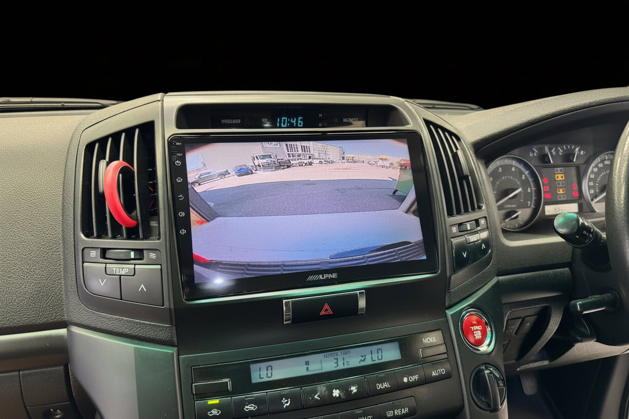 Car dashboard with a screen displaying a rearview camera view.