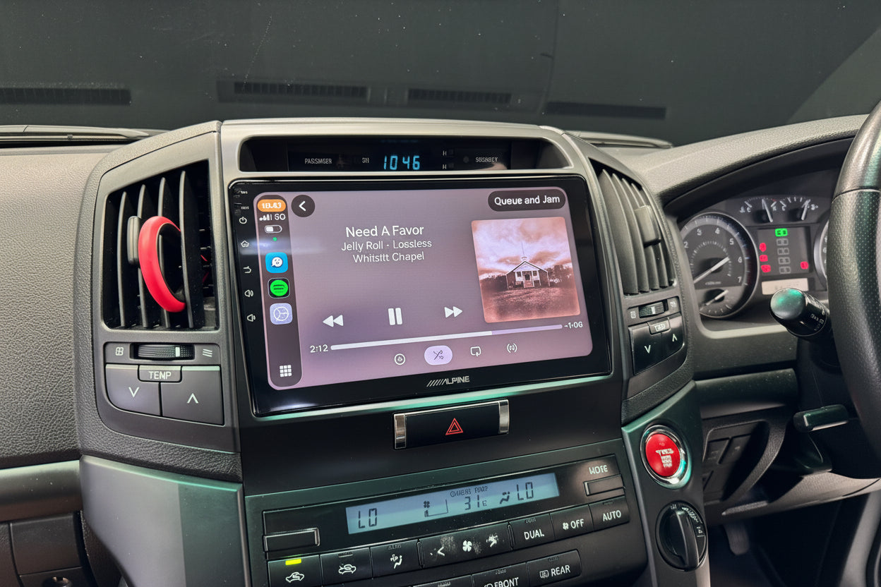 Car dashboard with a multimedia system displaying a music app interface.